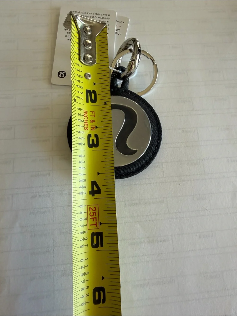 Lululemon Round Logo Keychain in Black and Silver